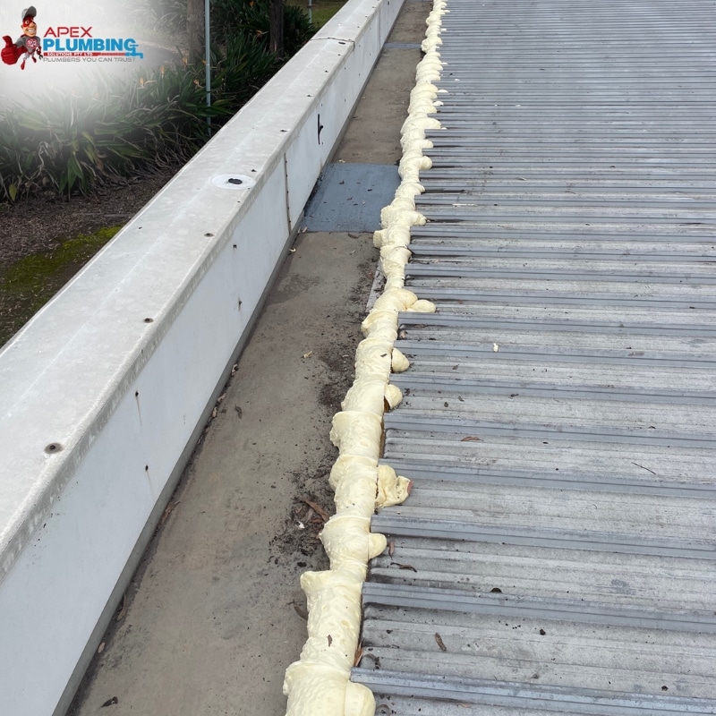 Roof with white foam applied carefully by Apex Plumbing Service's leaking roof repairs Sydney Wide.